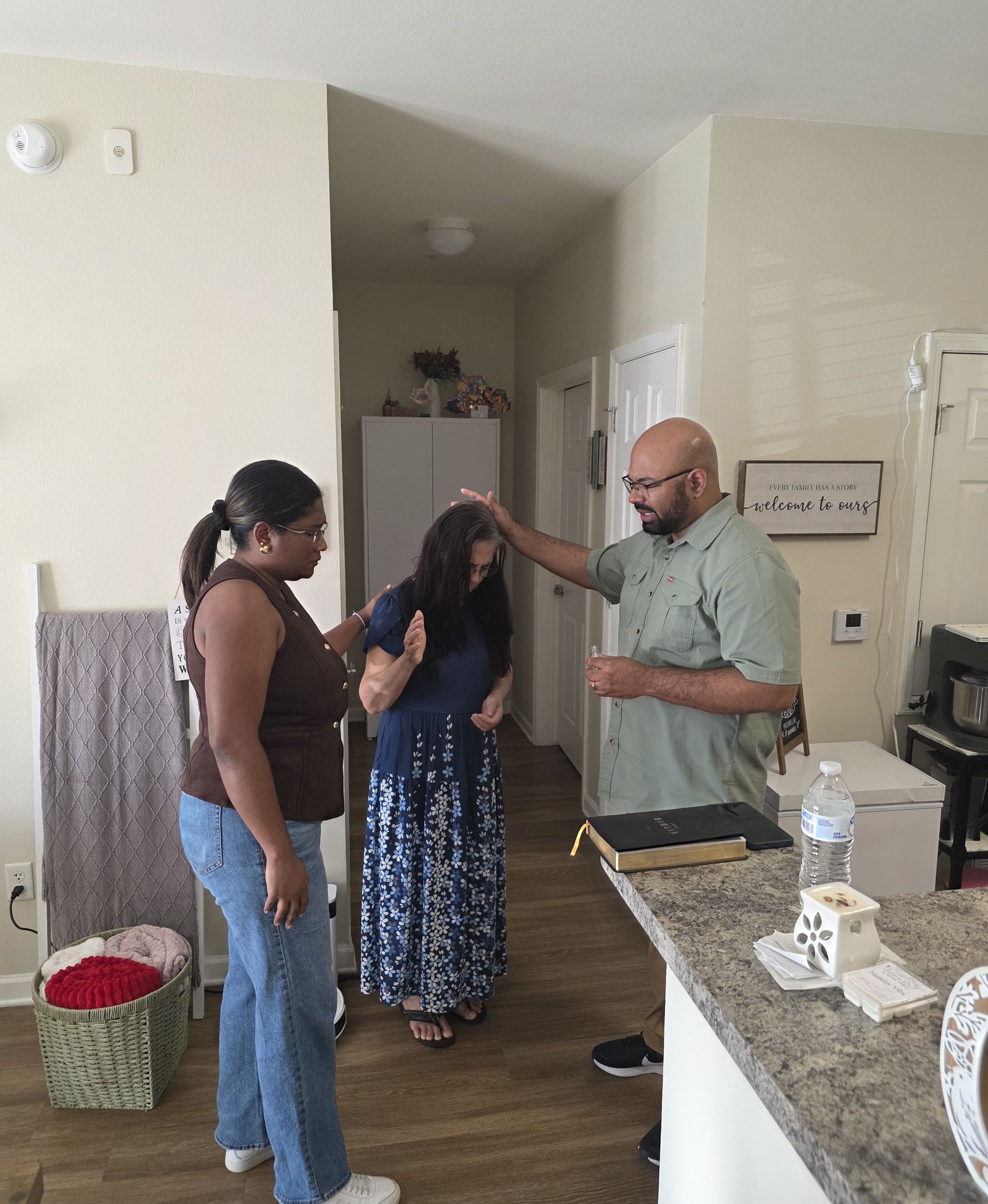 Pastor Kelsey and Jennifer praying with a Waypoint neighbor